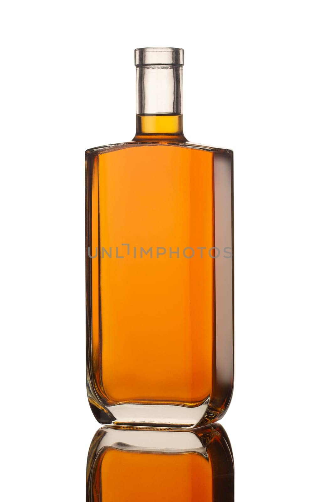 side view closeup of square modern shape cognac bottle with no label isolated on white background with reflection