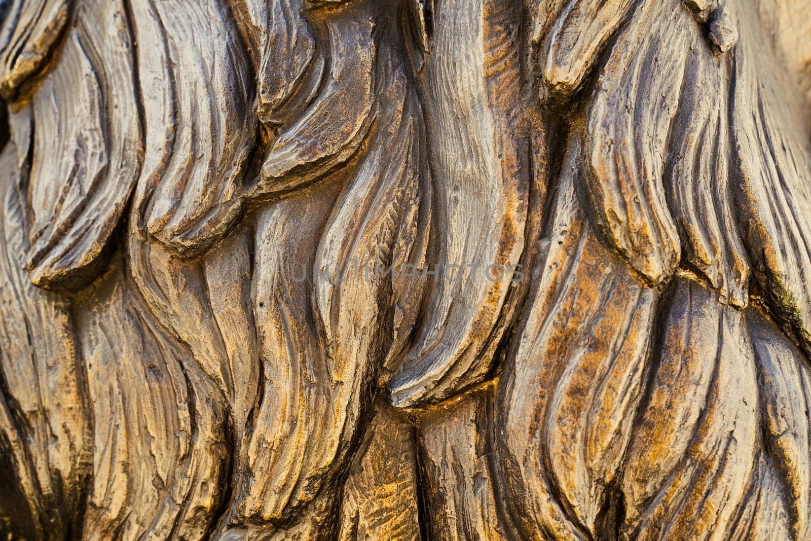 closeup front view of bronze sculpture strands of hair texture