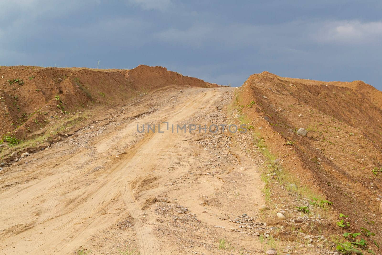 heap in the quarry sand against the blue sky