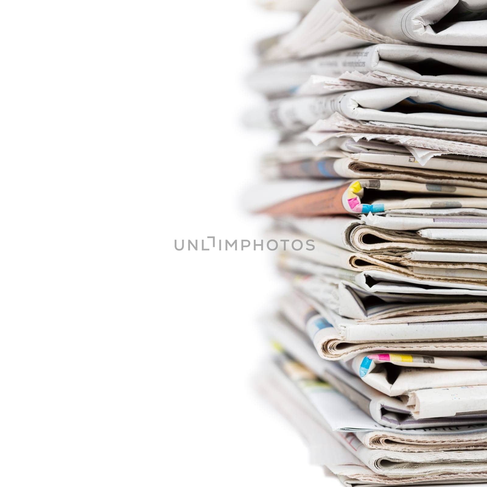 Pile of stacked generic folded newspapers background on white background with copy space. News and updates concept.