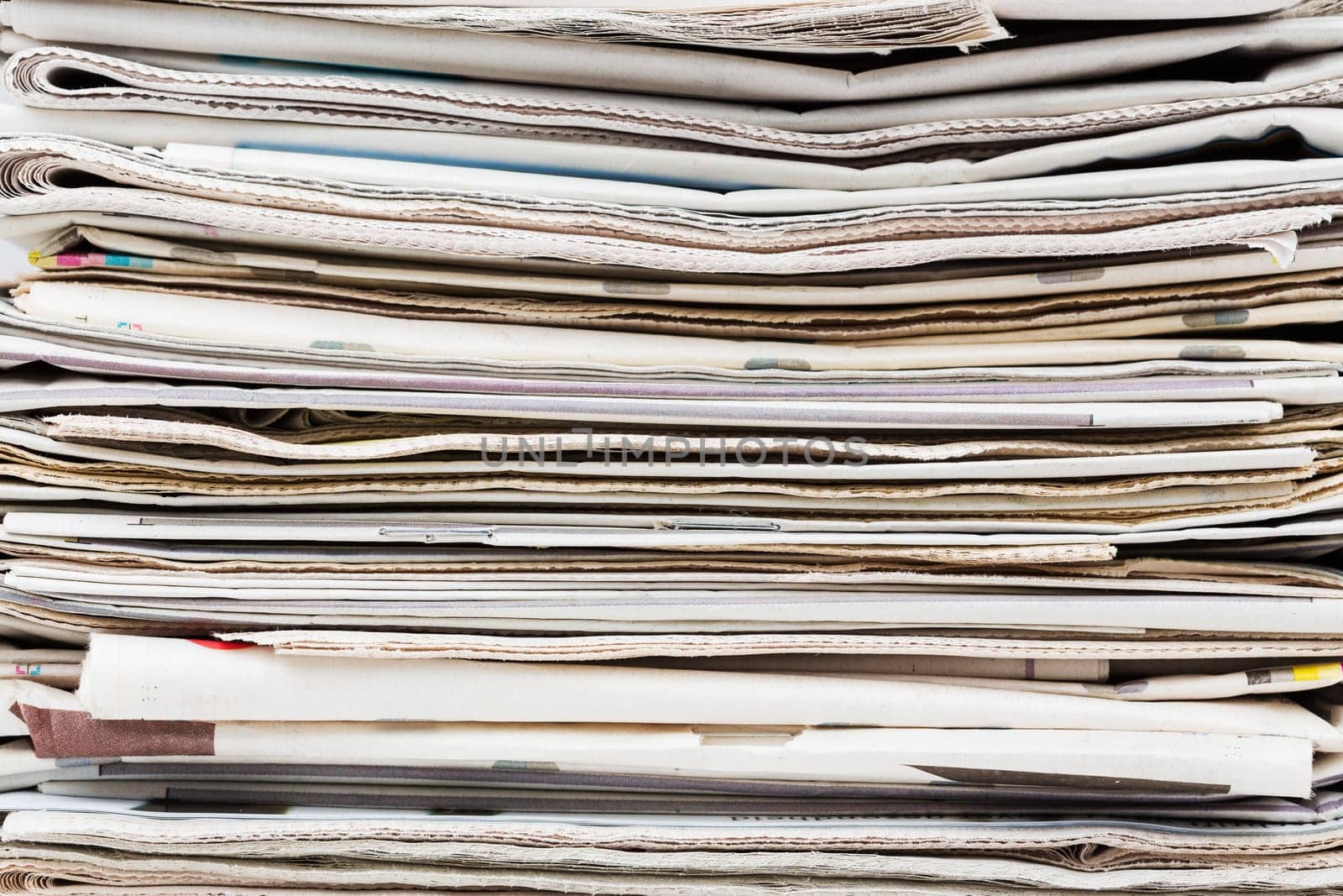 Pile of stacked generic folded newspapers background. News and updates concept.
