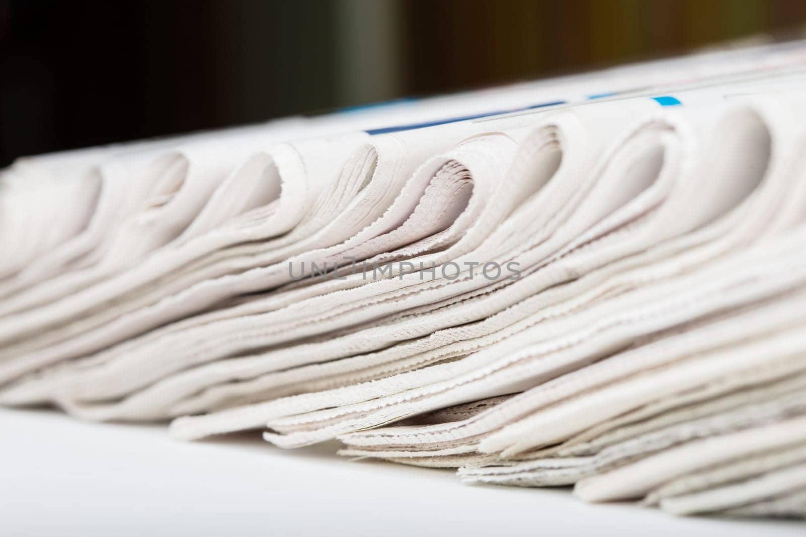 Assortment of folded newspapers closeup. Shallow DOF.