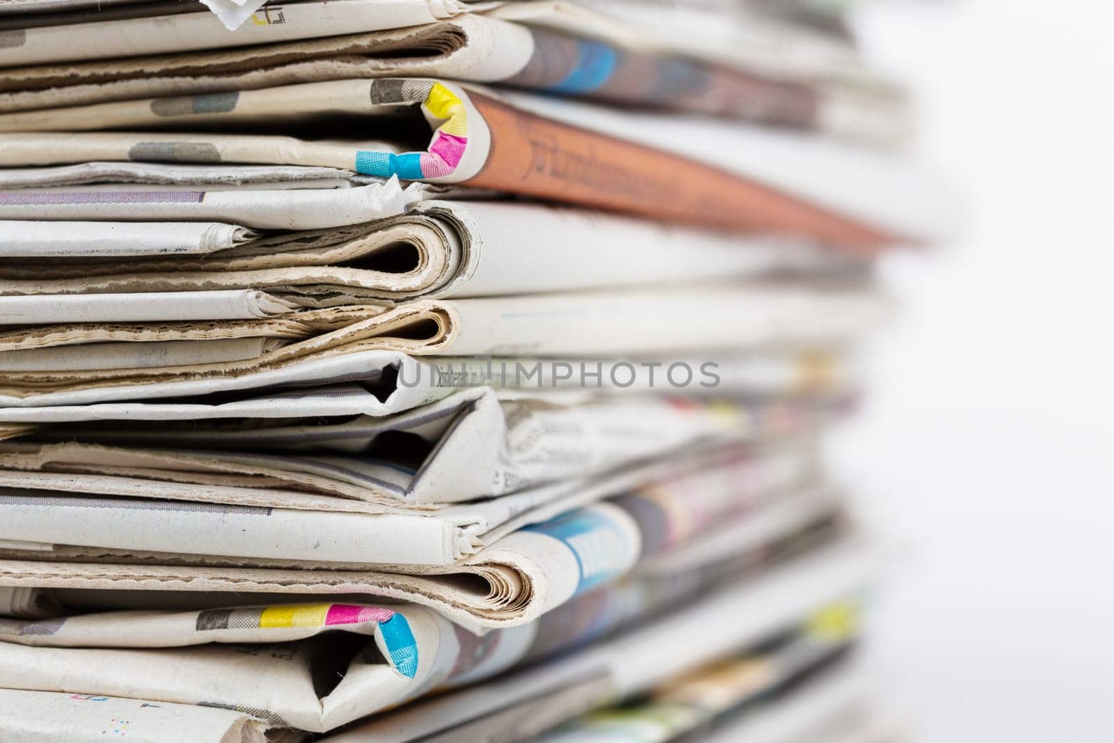 Stack of newspapers closeup shot. News and updates concept.