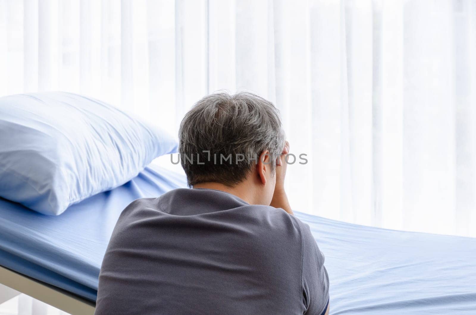 Elderly man feel grief suffer on patient bed for gone wife in hospital