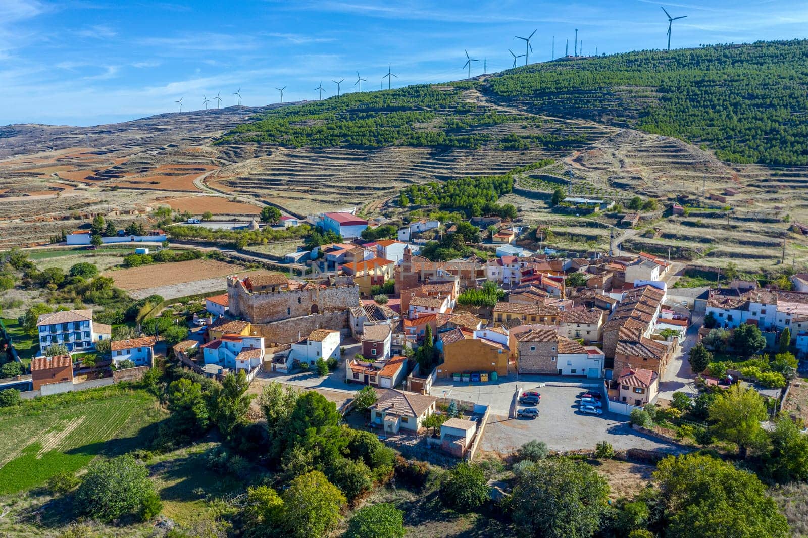 aerial view from drone of the population of Grisel and surroundings with the wind energy mills, near Tarazona in the province of Zaragoza in Spain