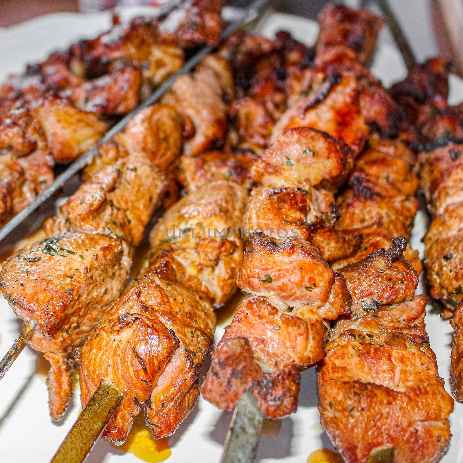 Russian shashlik with skewers on a white plate background in Norway.