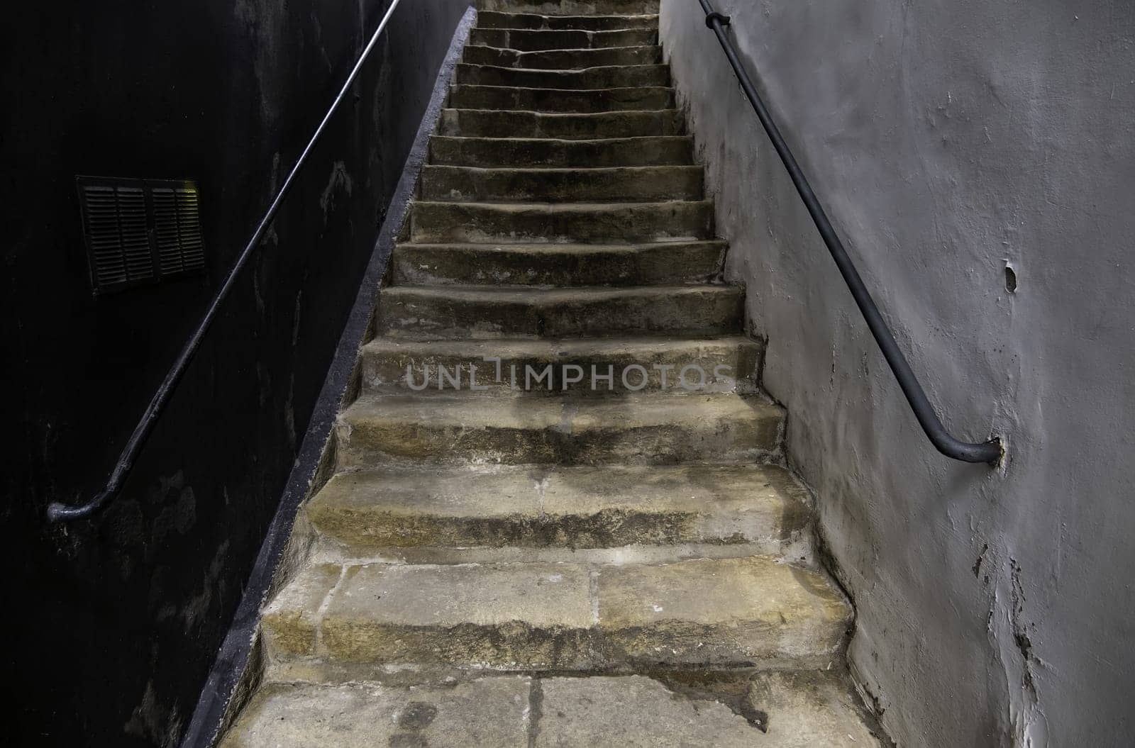 Detail of urban stairs in an old dark alley
