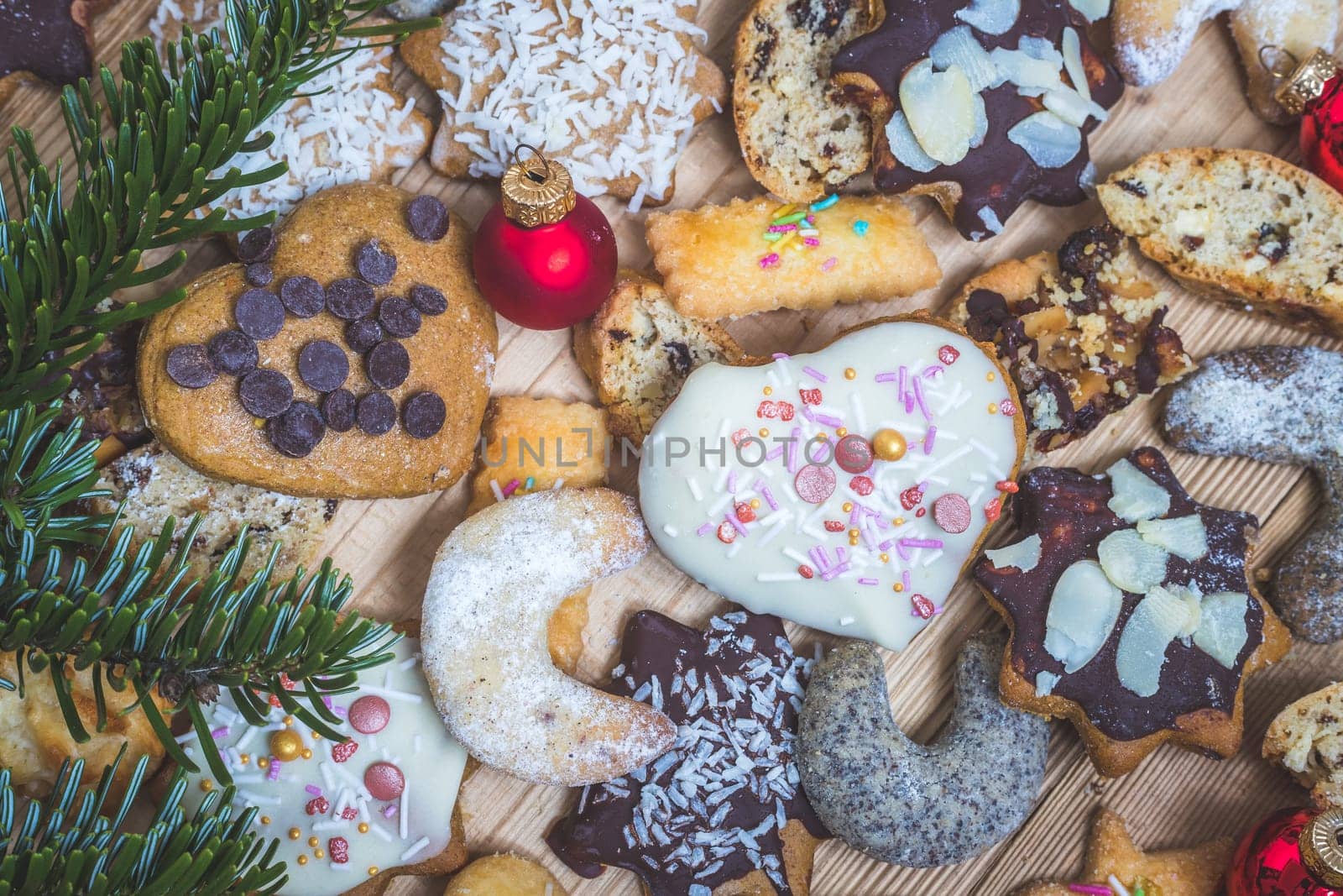 Homemade Christmas cookies, powdered sugar and Christmas bauble on a rustic wooden table