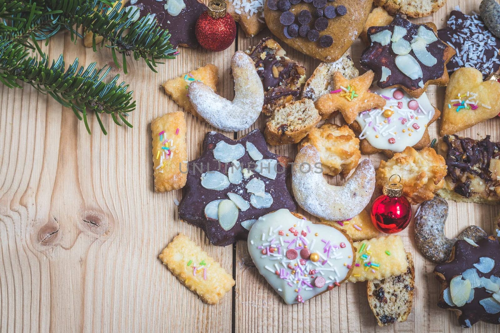Homemade Christmas cookies, powdered sugar and Christmas bauble on a rustic wooden table
