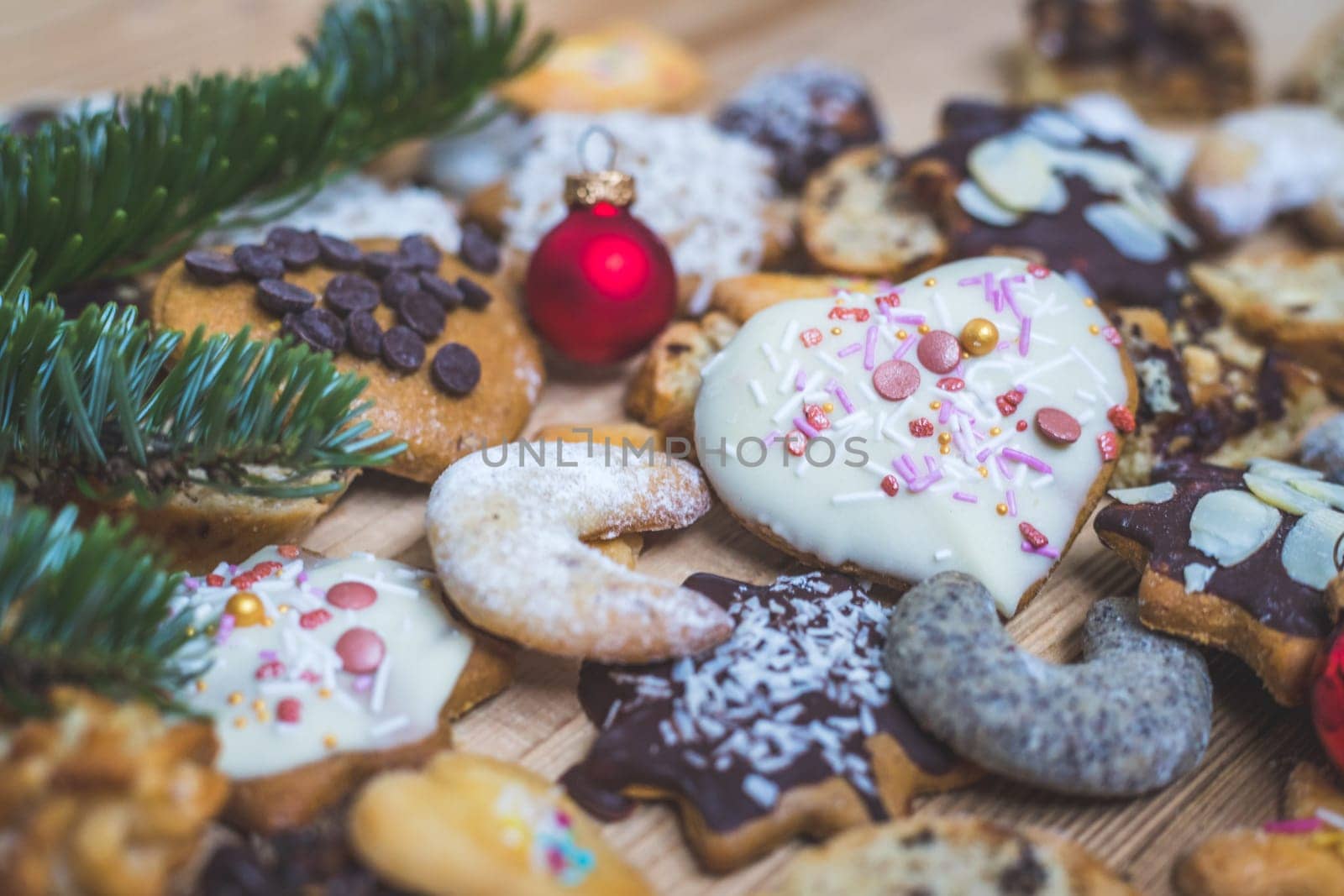 Homemade Christmas cookies, powdered sugar and Christmas bauble on a rustic wooden table