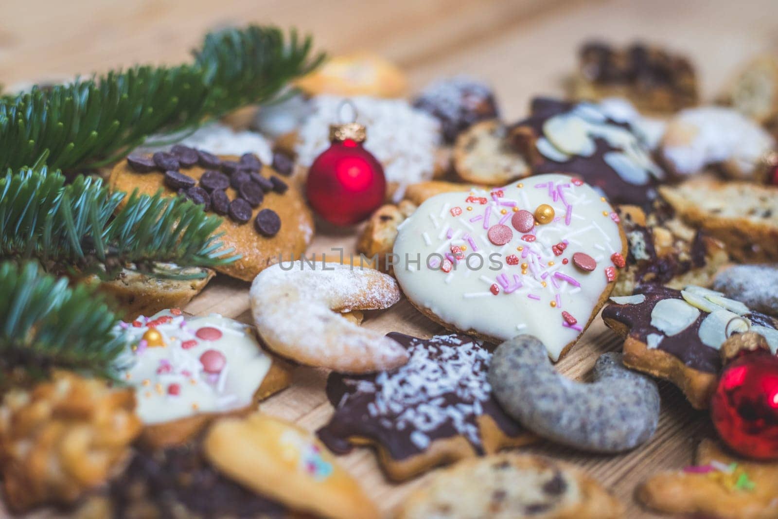 Homemade Christmas cookies, powdered sugar and Christmas bauble on a rustic wooden table