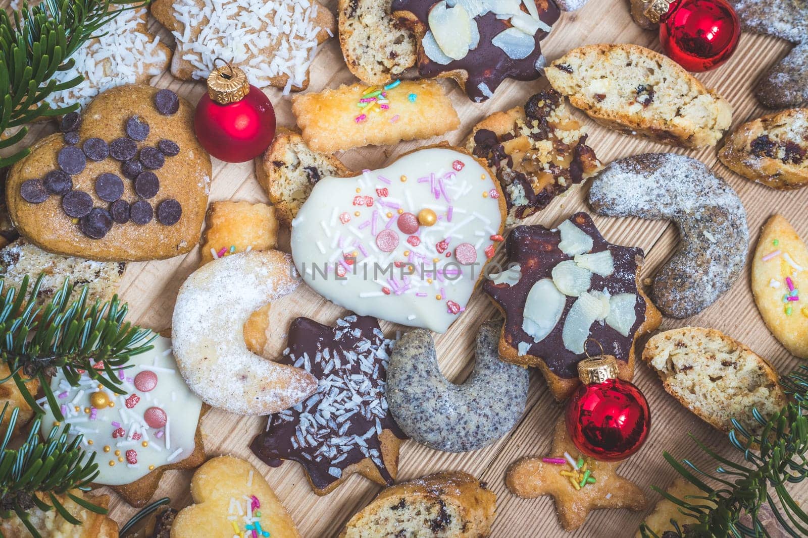 Homemade Christmas cookies, powdered sugar and Christmas bauble on a rustic wooden table