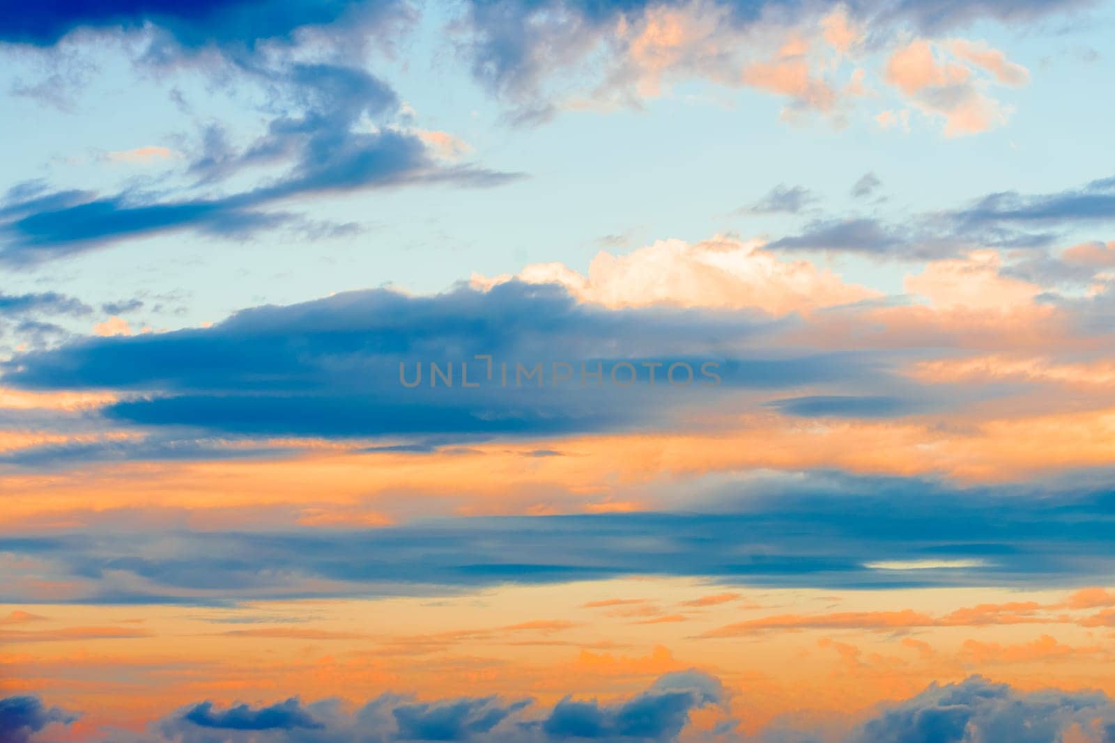 Beautiful evening sky with pink clouds. Sunset over the sea