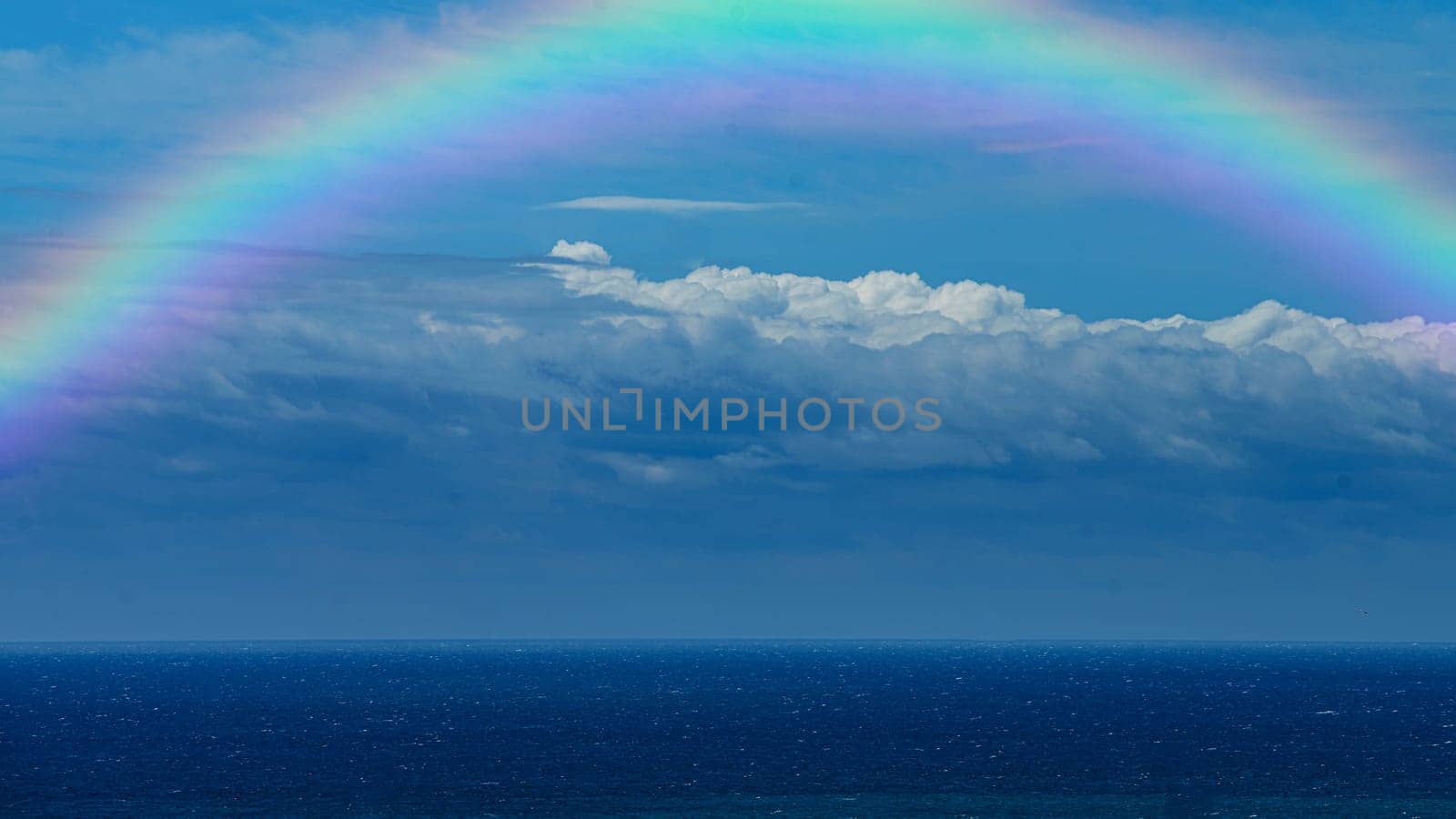 Beautiful sea with a rainbow in the sky