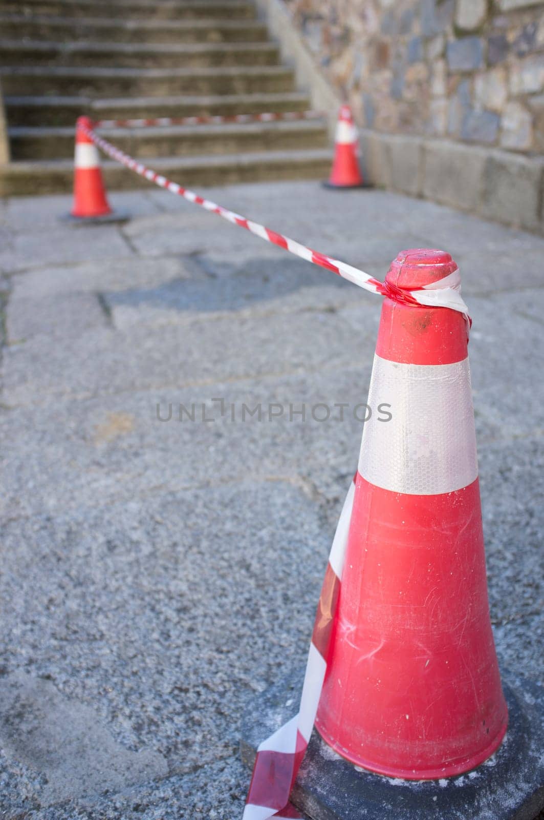 Security area marked by cones and tape. Selective focus