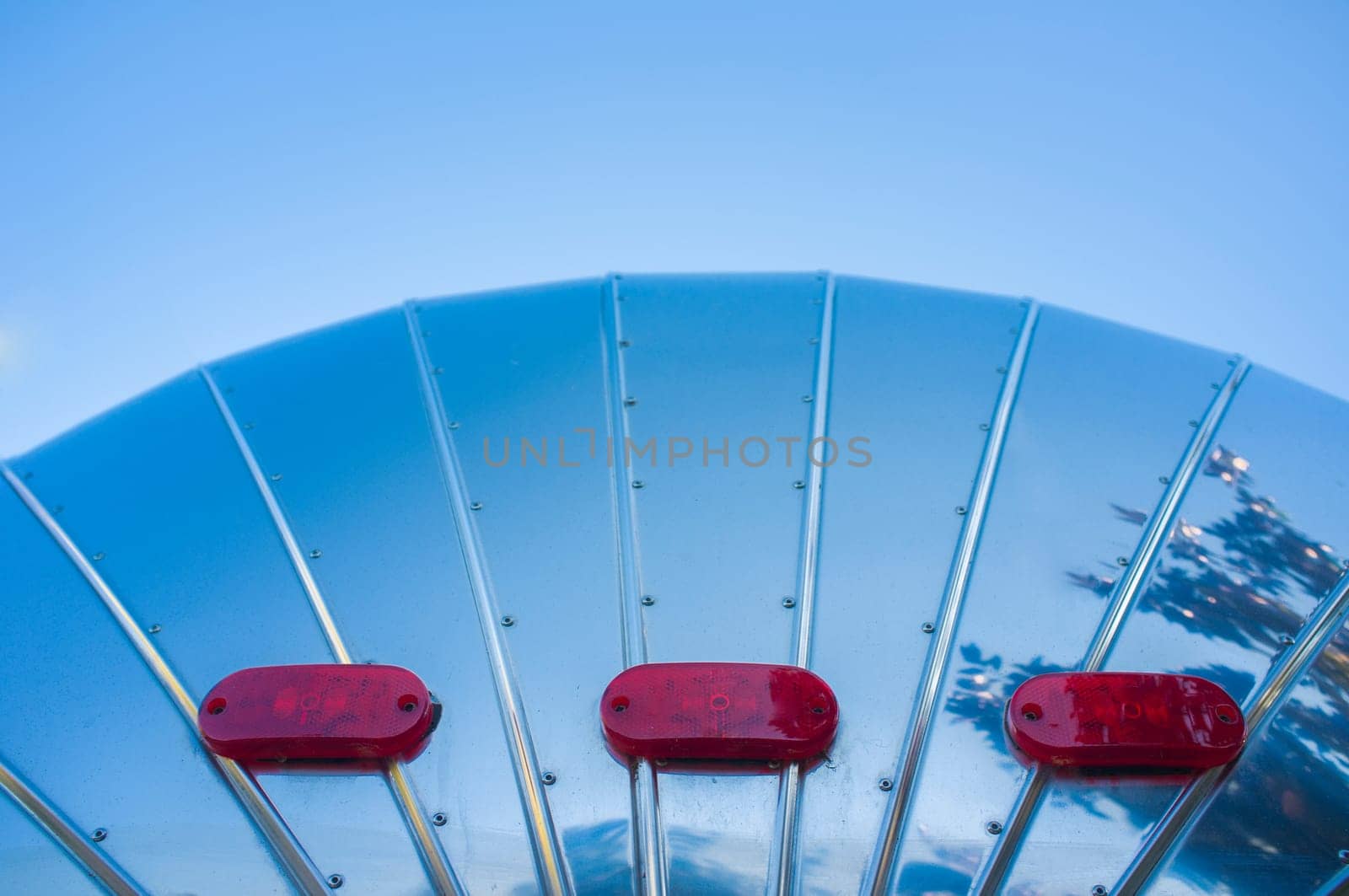 Rounded metal american caravan used as mobile catering vehicle. Rear view