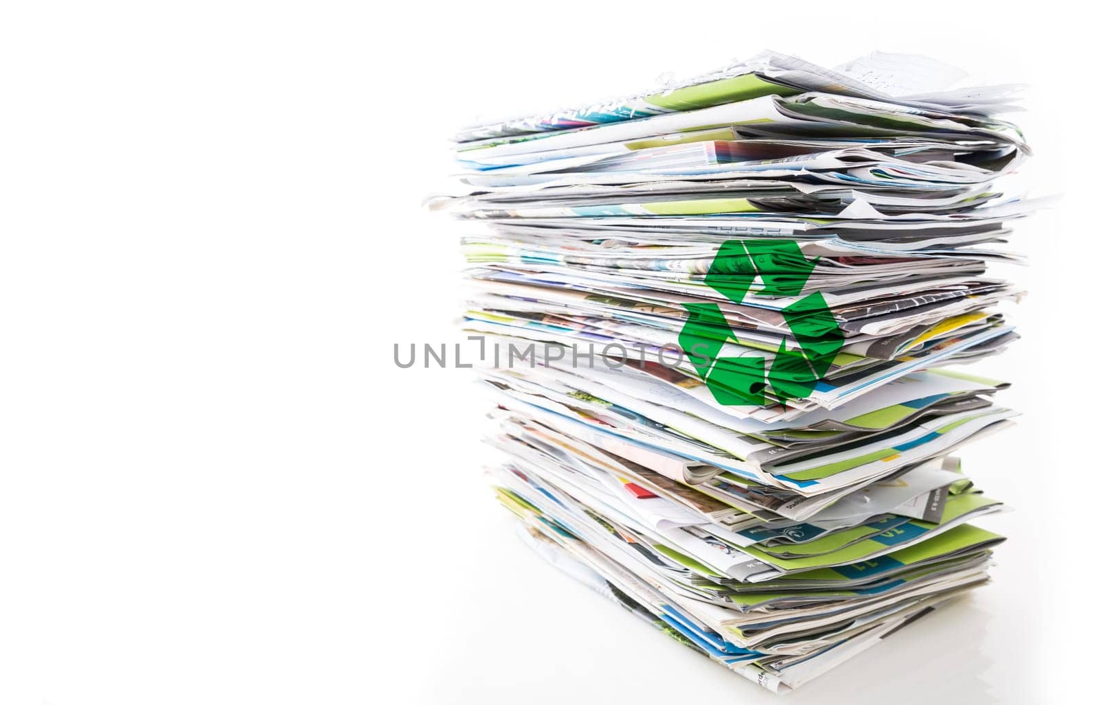 Stack of waste paper, old magazines, newspapers and leaflets for recycling isolated on white