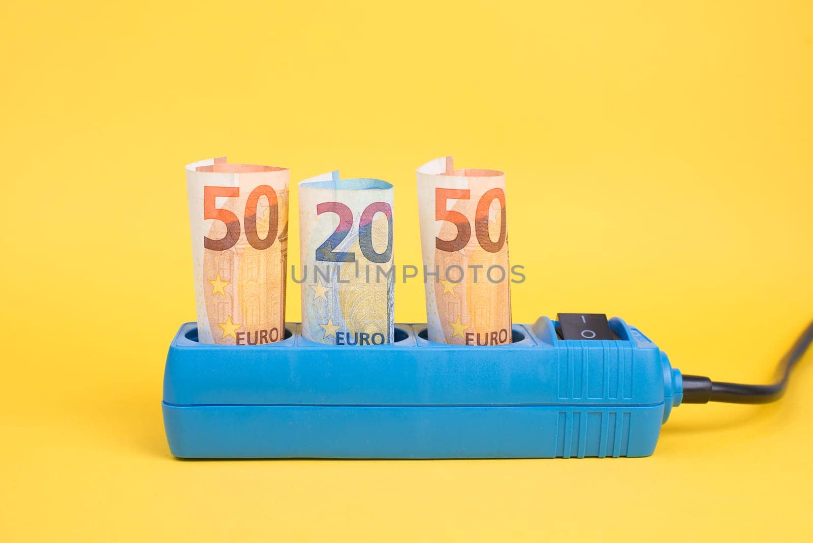 Euro banknotes in a power outlet, rising prices, expensive green electricity, Germany