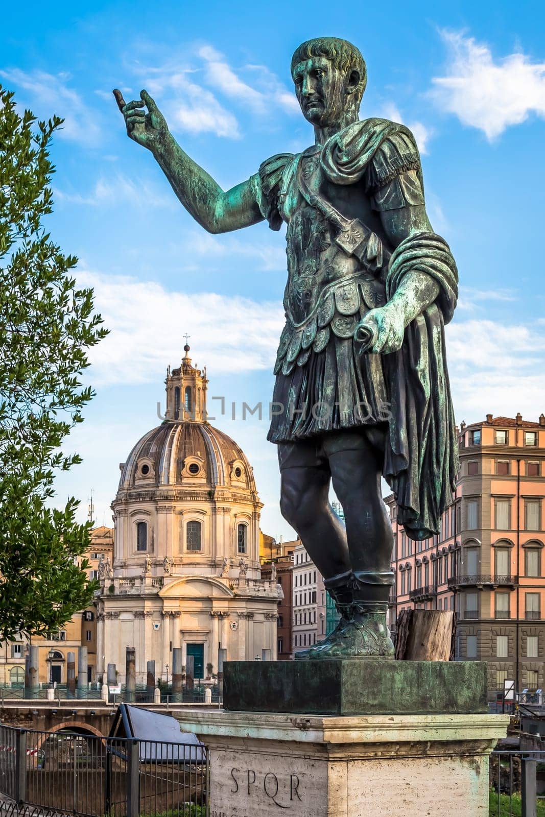 ITALY, ROME - CIRCA AUGUST 2020: Statue of Caesar Emperor, made of bronze. Natural sunrise light. Ancient  role model of Leadeship and Authority .