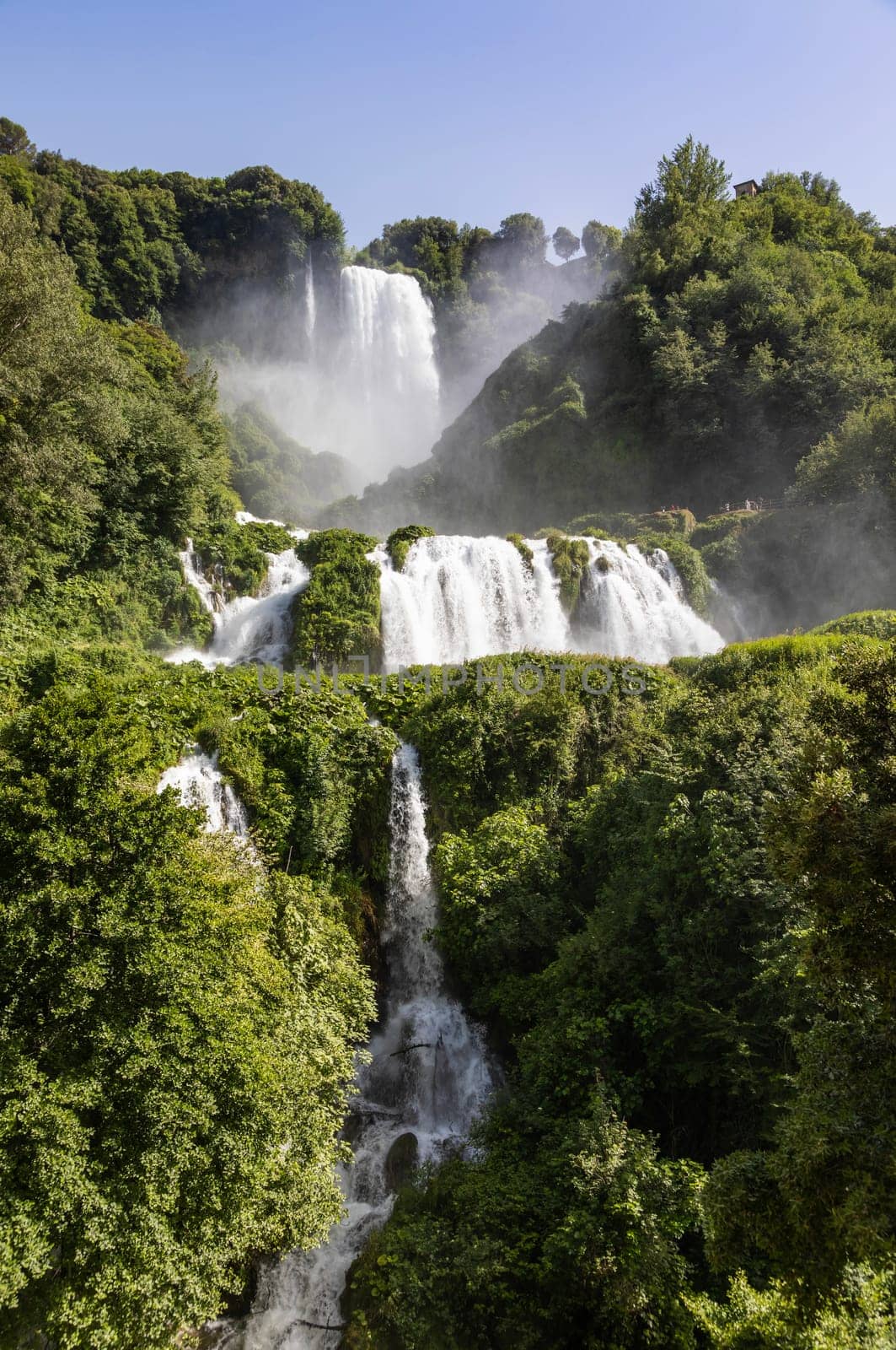 Marmore waterfall in Umbria region, Italy. Amazing cascade splashing into nature with trees and rocks.