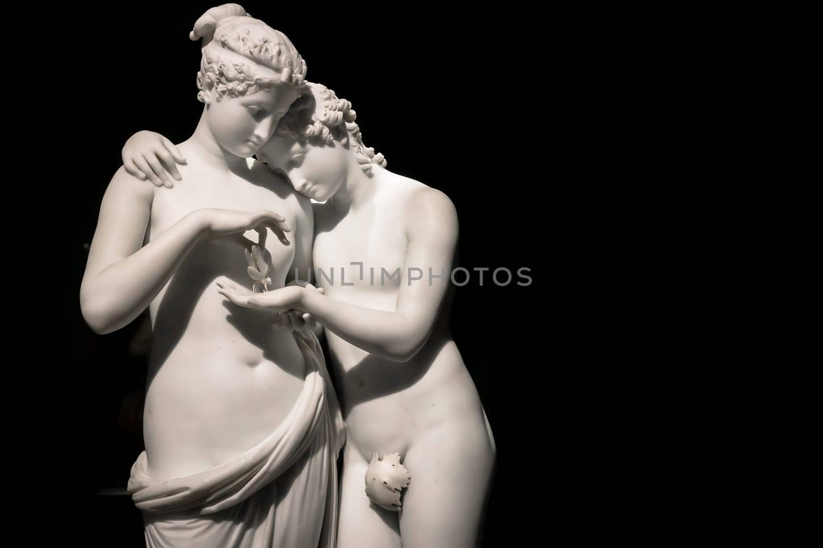 MILAN, ITALY - June 2020. Antonio Canova's masterpiece Cupid and Psyche (Amore e psiche, 1797), symbol of eternal love. Psyche raises Cupid left hand with her own, to place a butterfly on his palm. The butterfly symbolizes her soul, which she offers in all innocence to Cupid.