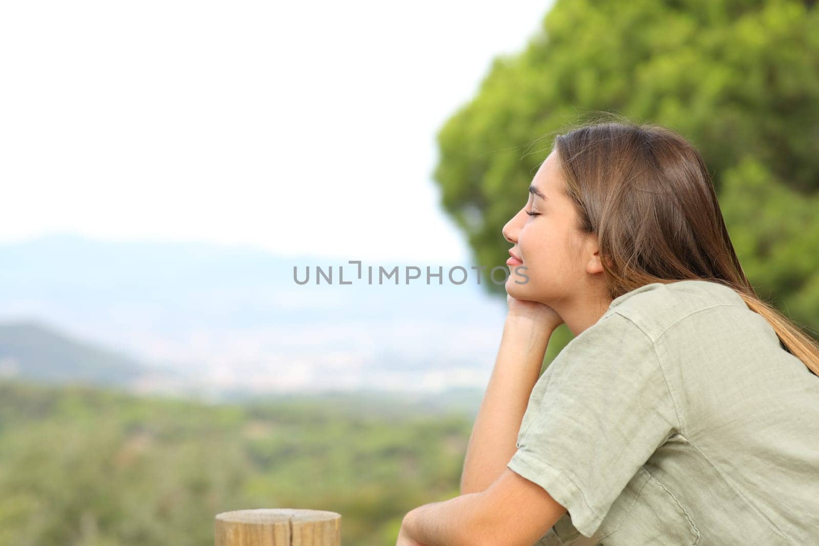 Profile of a happy teen relaxing mind in the mountain