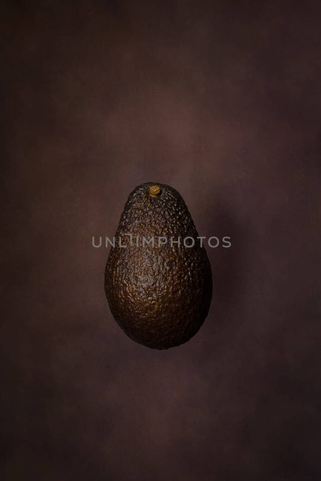 Fresh avocado on dark background. Vegetarian food concept.