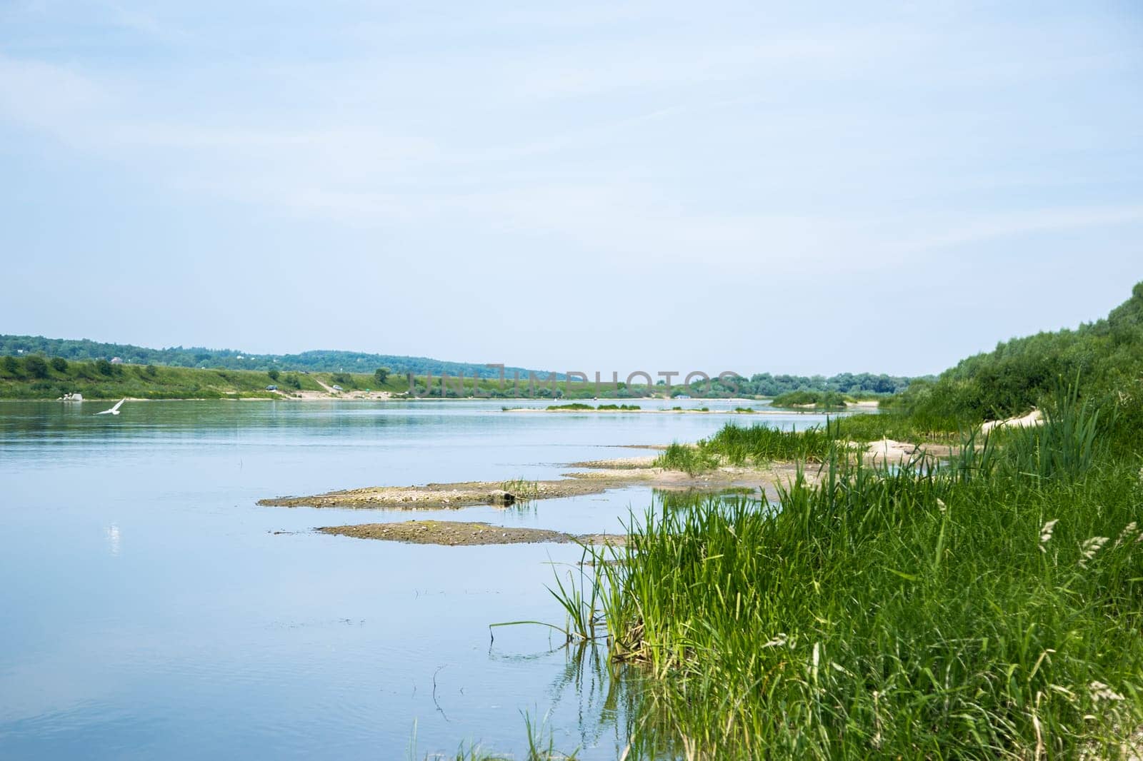 View of the Oka river from the shore, the opposite Bank is visible . The sky is reflected in the water. High quality photo