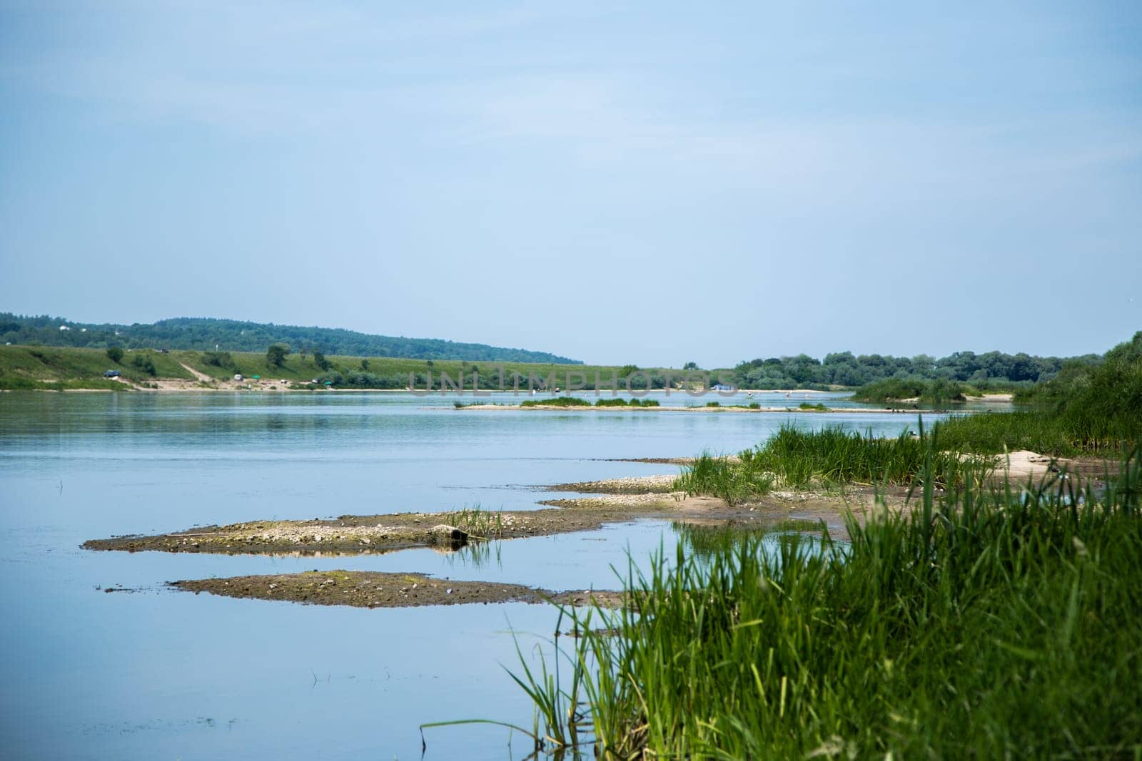View of the Oka river from the shore, the opposite Bank is visible . The sky is reflected in the water. High quality photo