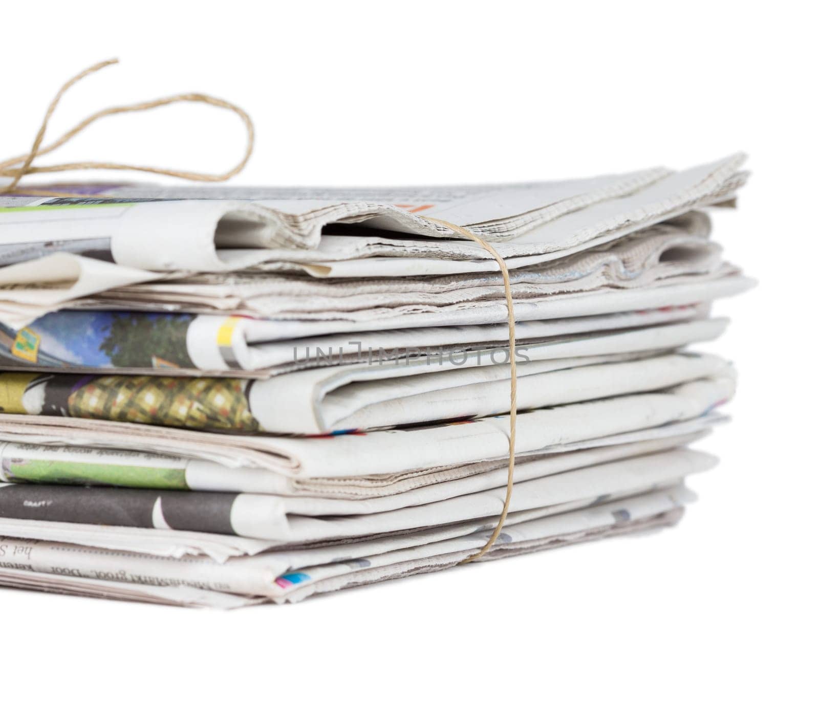 Pile of stacked generic folded newspapers background on white background with copy space. News and updates concept.