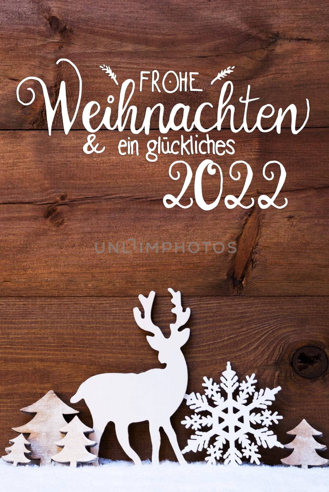 German Calligraphy Frohe Weihnachten Und Ein Glueckliches 2022 Means Merry Christmas And Happy 2022. Christmas Decoration Like Snowflake, Tree And Deer. Brown Wooden Background