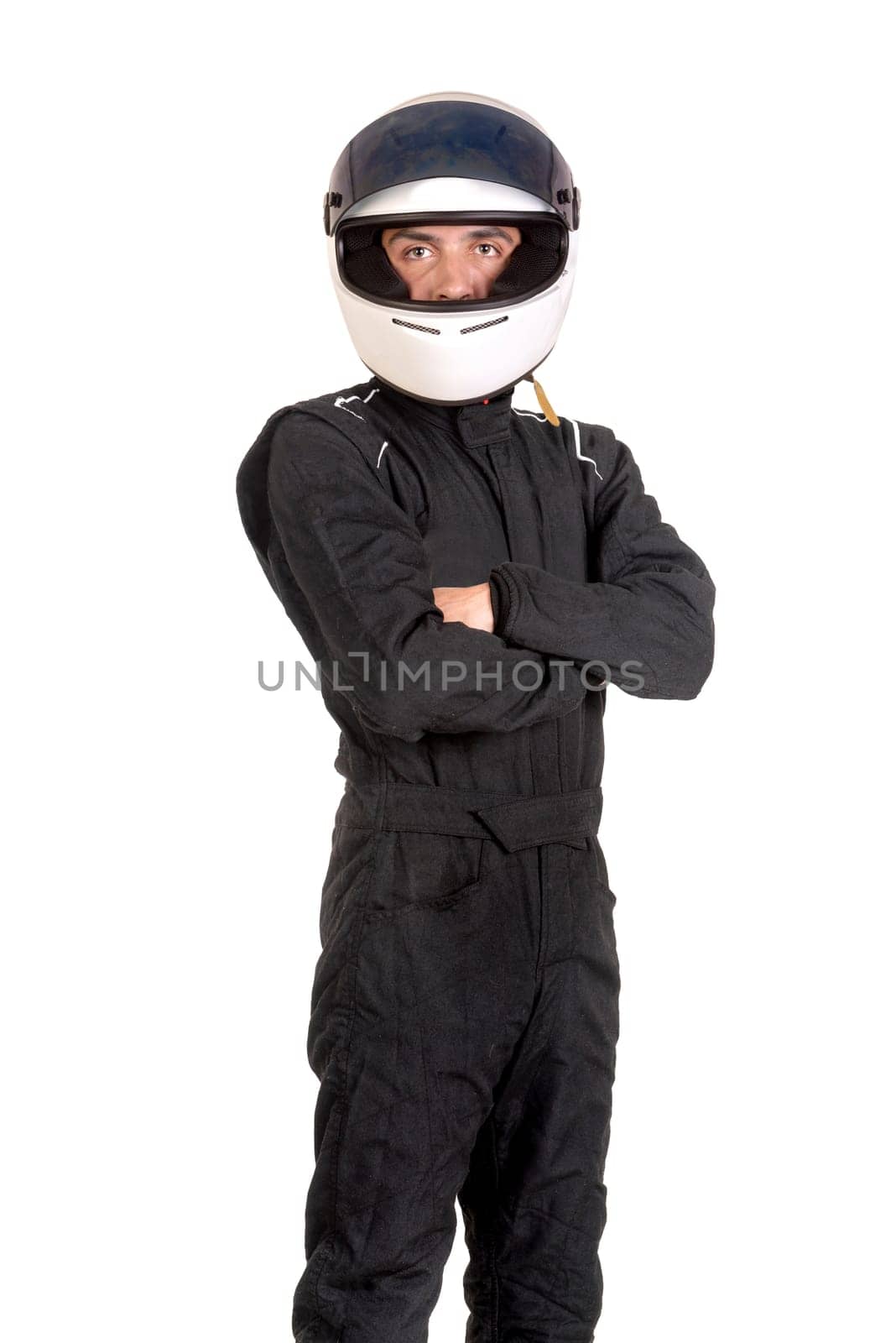 Racing driver posing with helmet isolated in white