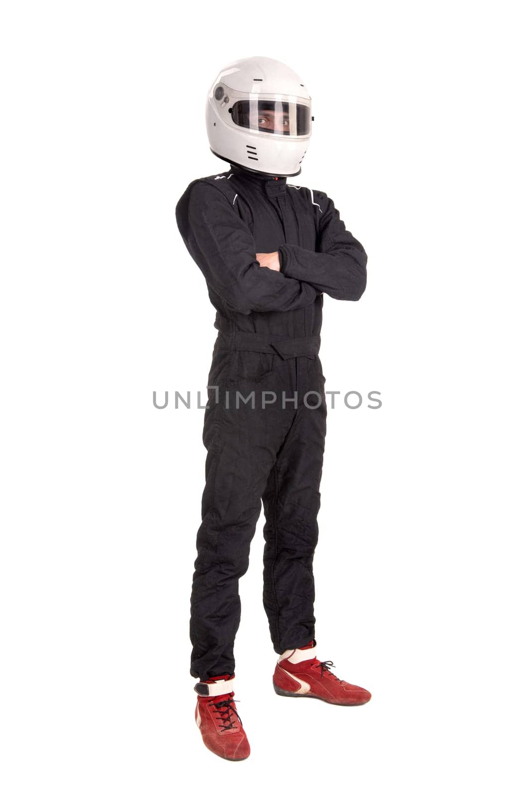 Racing driver posing with helmet isolated in white