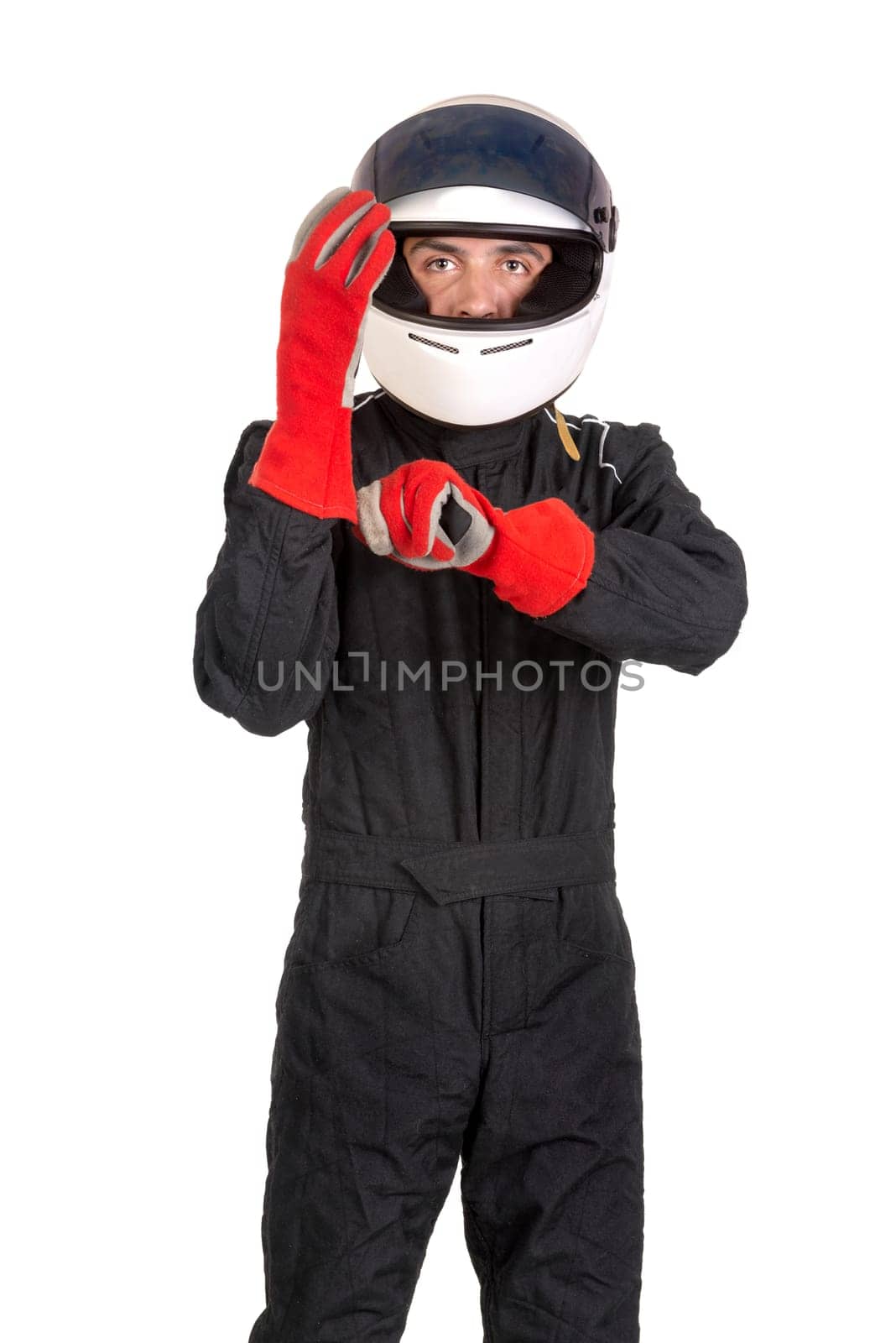 Racing driver putting on his gloves with helmet isolated in white