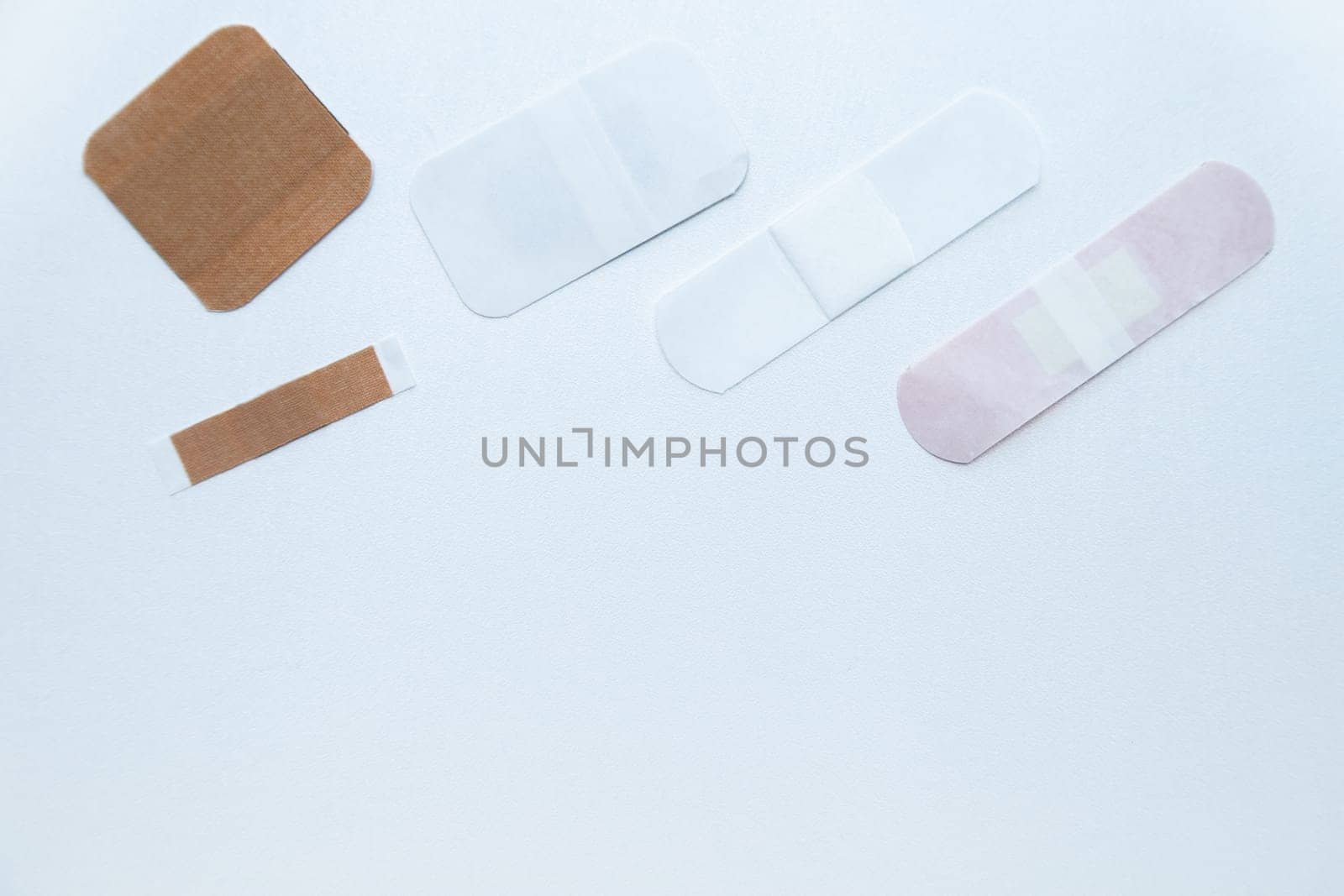 Bactericidal patches of various shapes and sizes lie on a white background with a place for text. High quality photo
