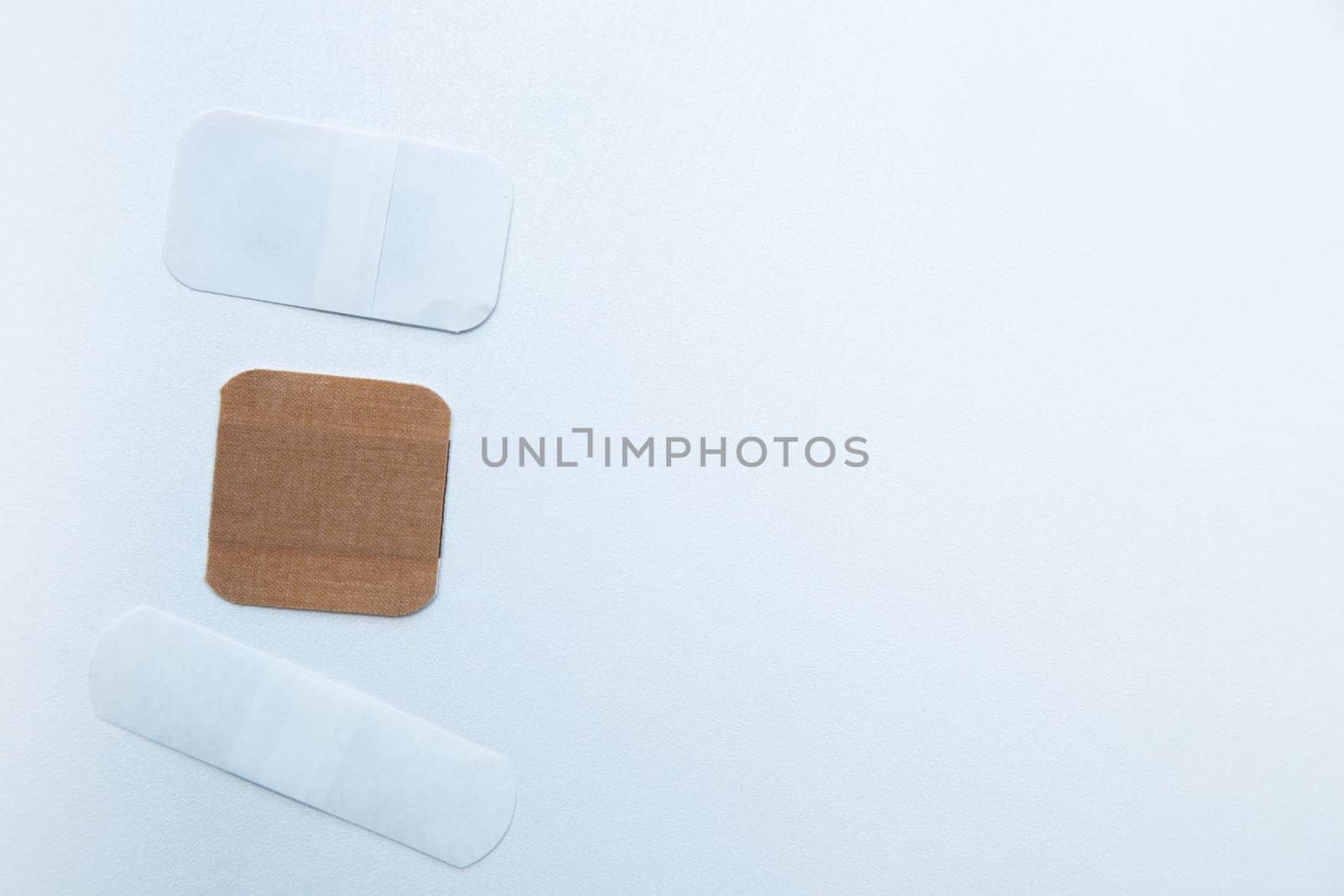Bactericidal patches of various shapes and sizes lie on a white background with a place for text. High quality photo