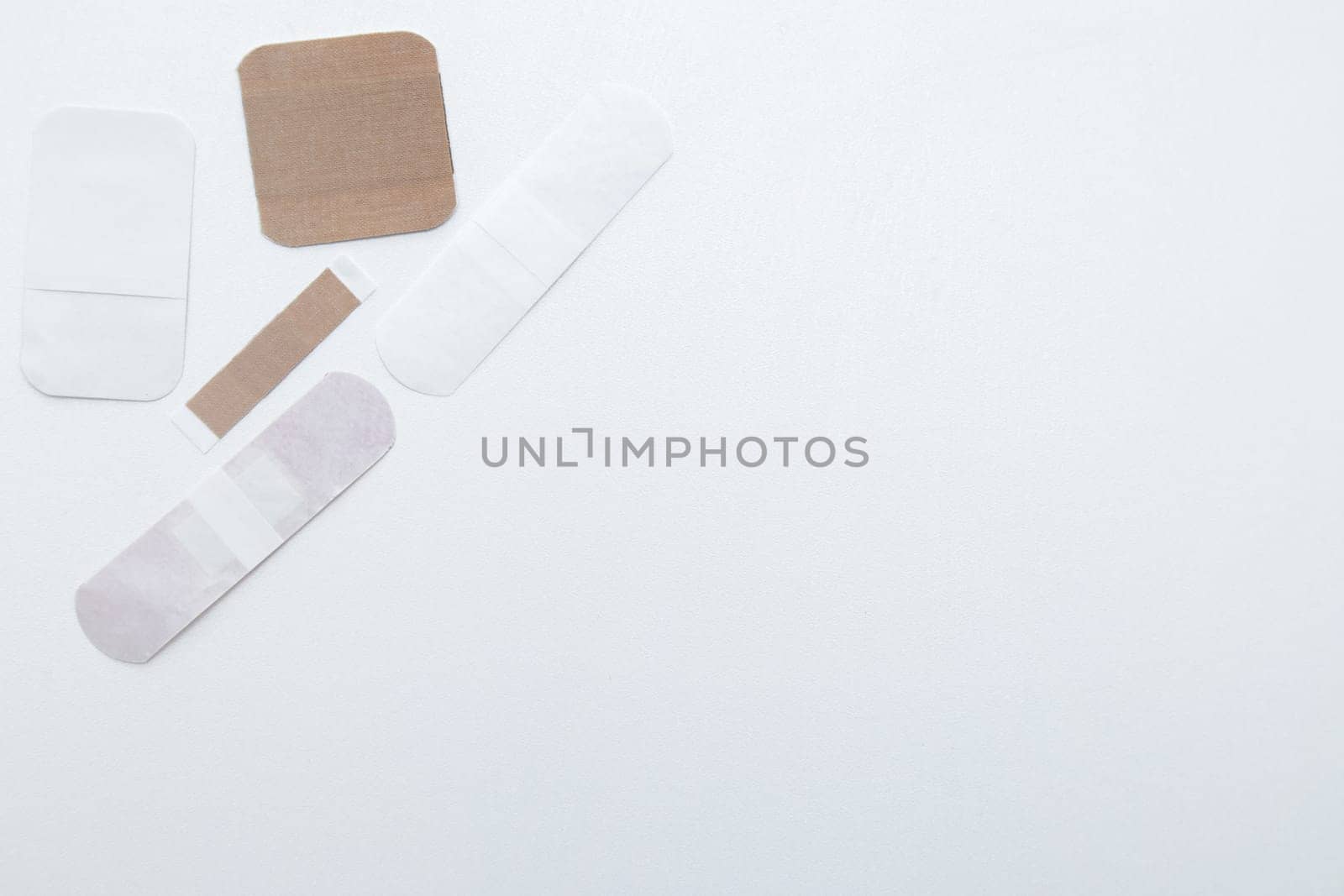 Bactericidal patches of various shapes and sizes lie on a white background with a place for text. High quality photo