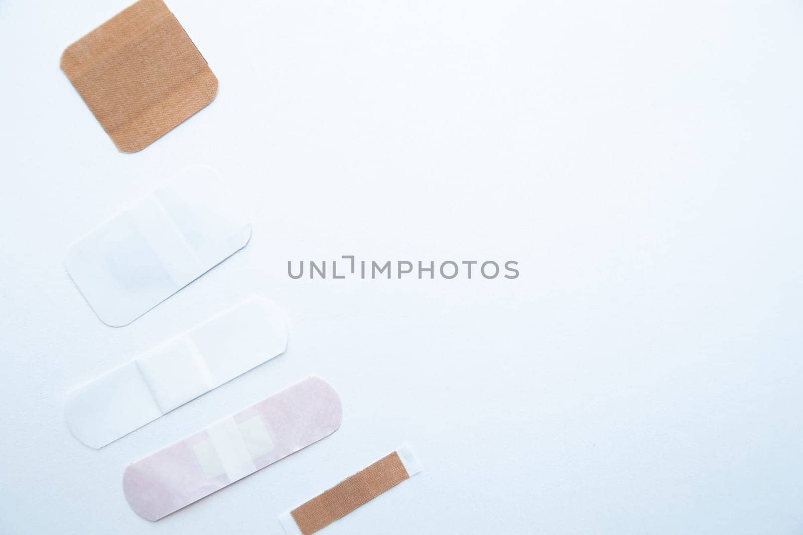 Bactericidal patches of various shapes and sizes lie on a white background with a place for text. High quality photo