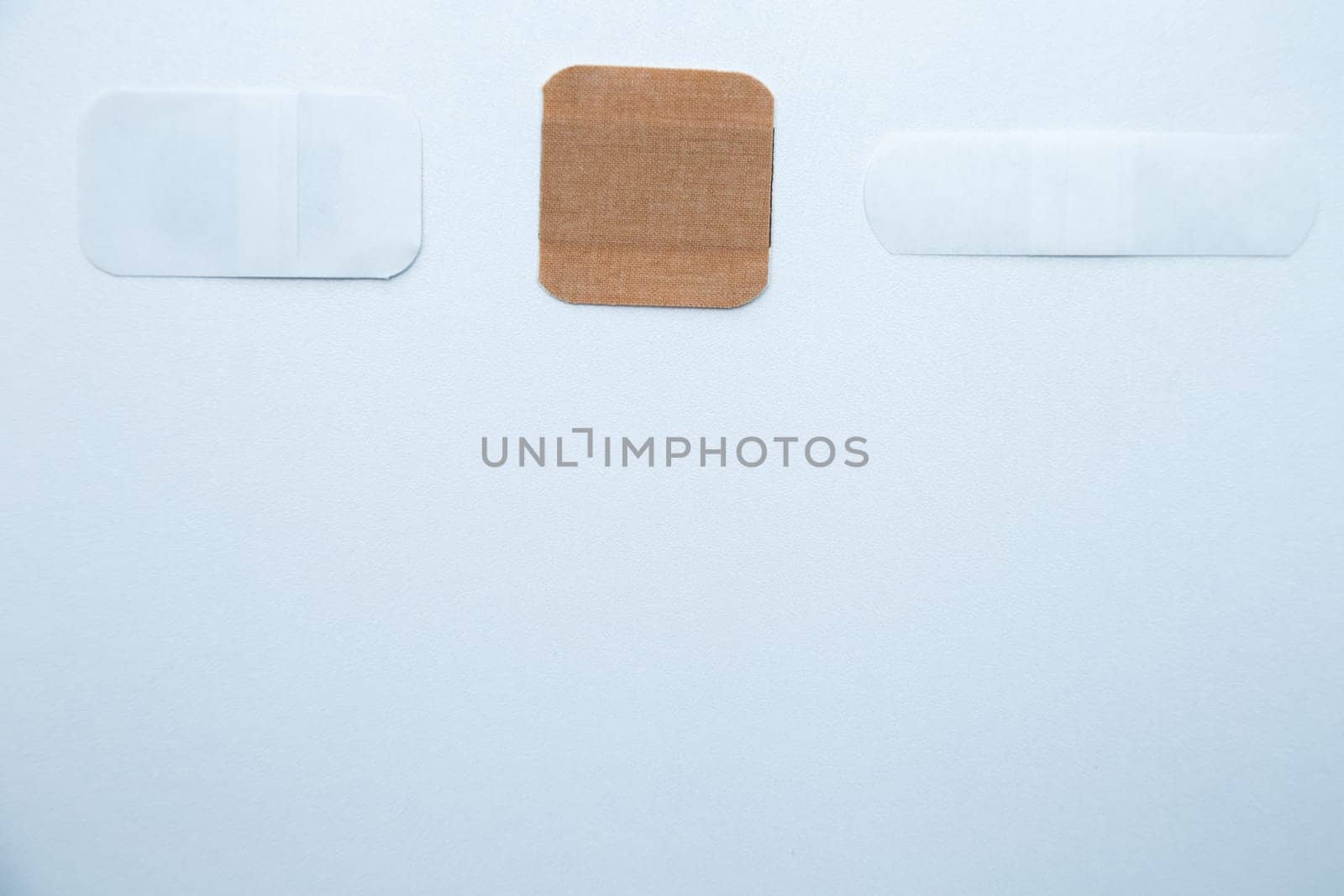 Bactericidal patches of various shapes and sizes lie on a white background with a place for text. High quality photo