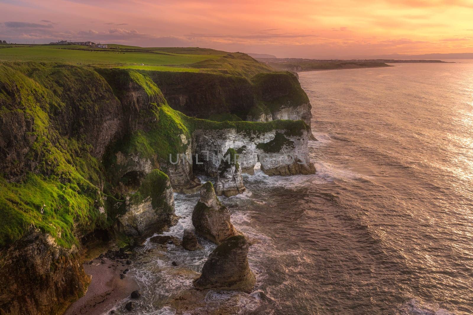 Beautiful white, limestone cliffs seen from Magheracross viewpoint at dramatic sunset, Bushmills, Northern Ireland