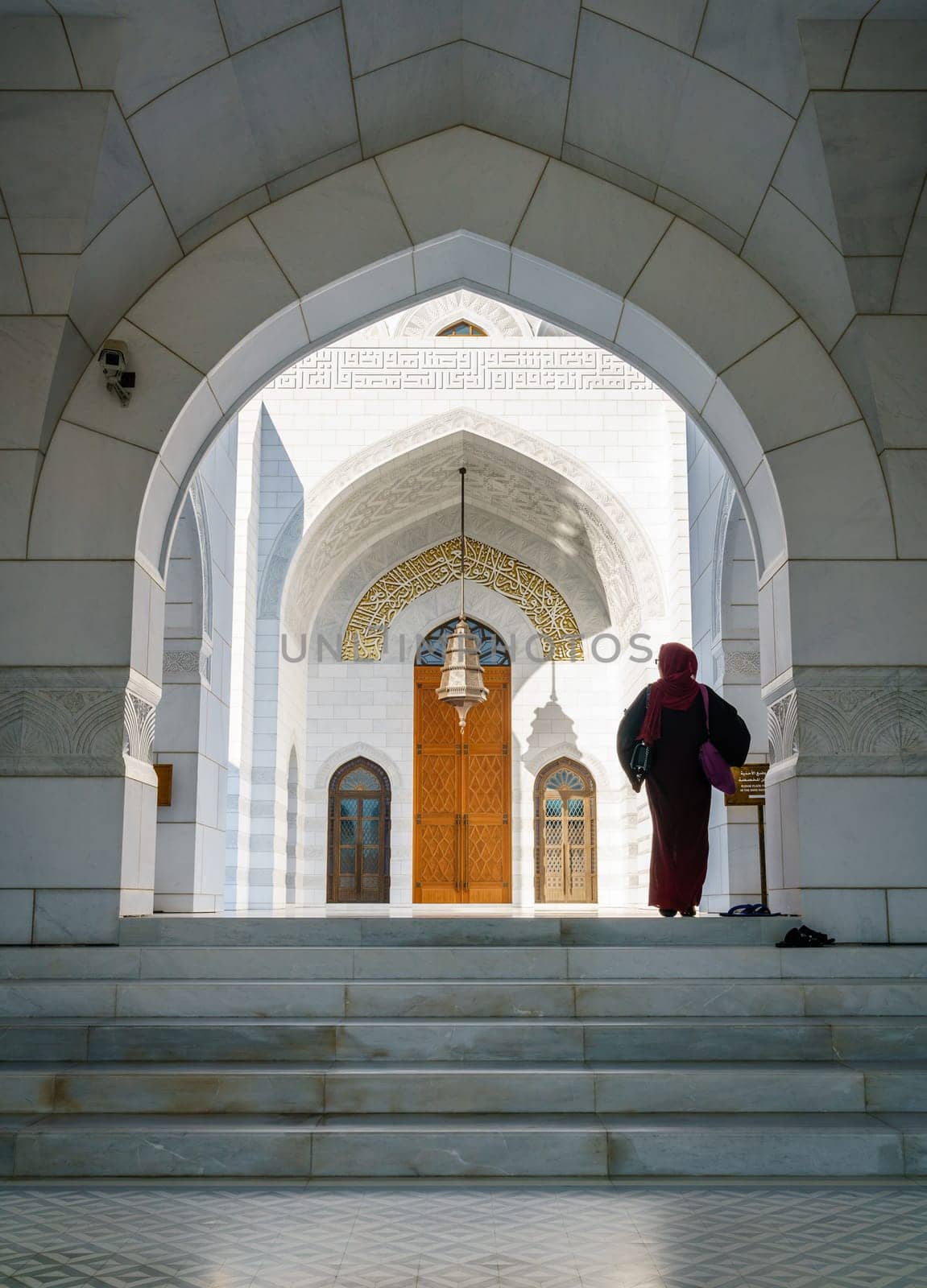 December 4, 2016, Muscat, Oman: a woman is walking towards an entrance to the prayer hall of Mosque Muhammad al-Amin in Muscat, Oman