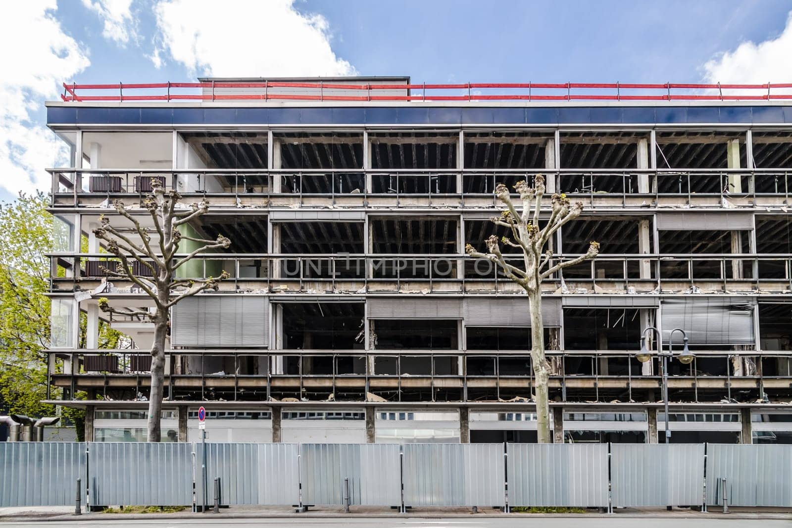 Demolition of a multi storey office complex with barriers of aluminium wall