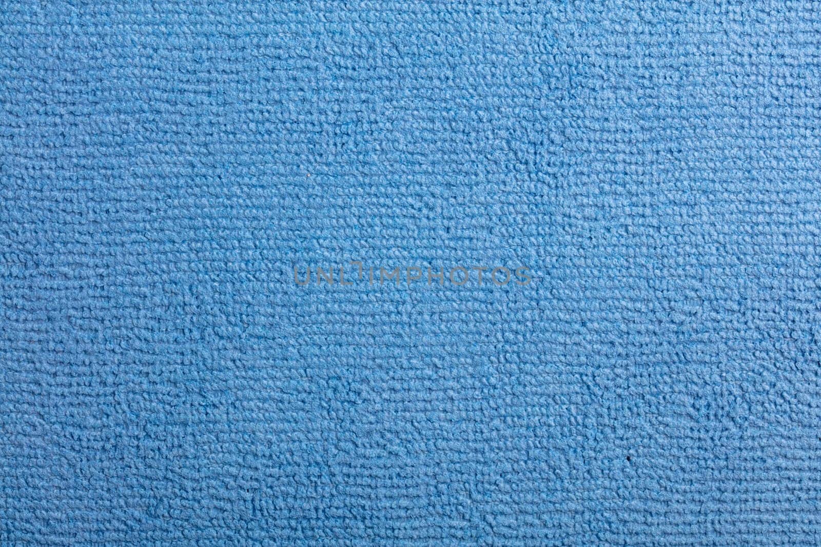 Microfiber Towel Blue Terry Texture Wrist Watch. Microfiber cloth with close-up. Fabric structure background. Fabric blue pattern. Cleaning service. Macro object.