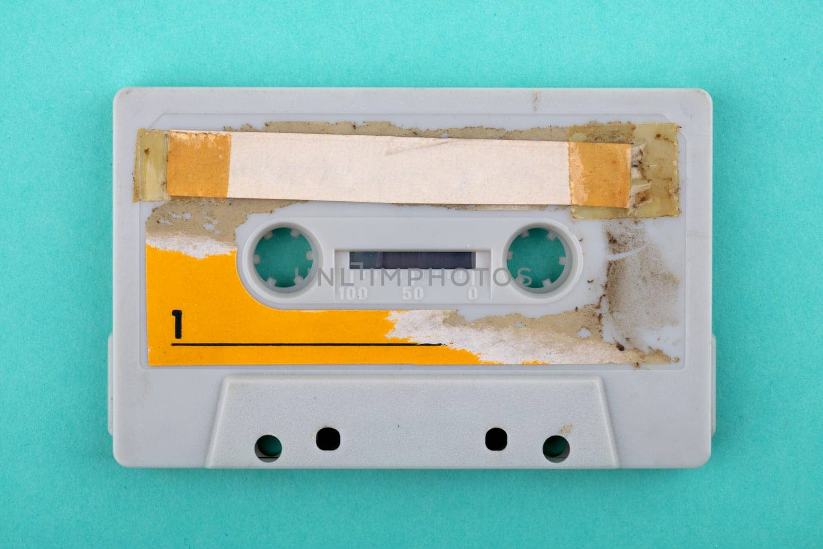 Old used audio tape isolated over green Background