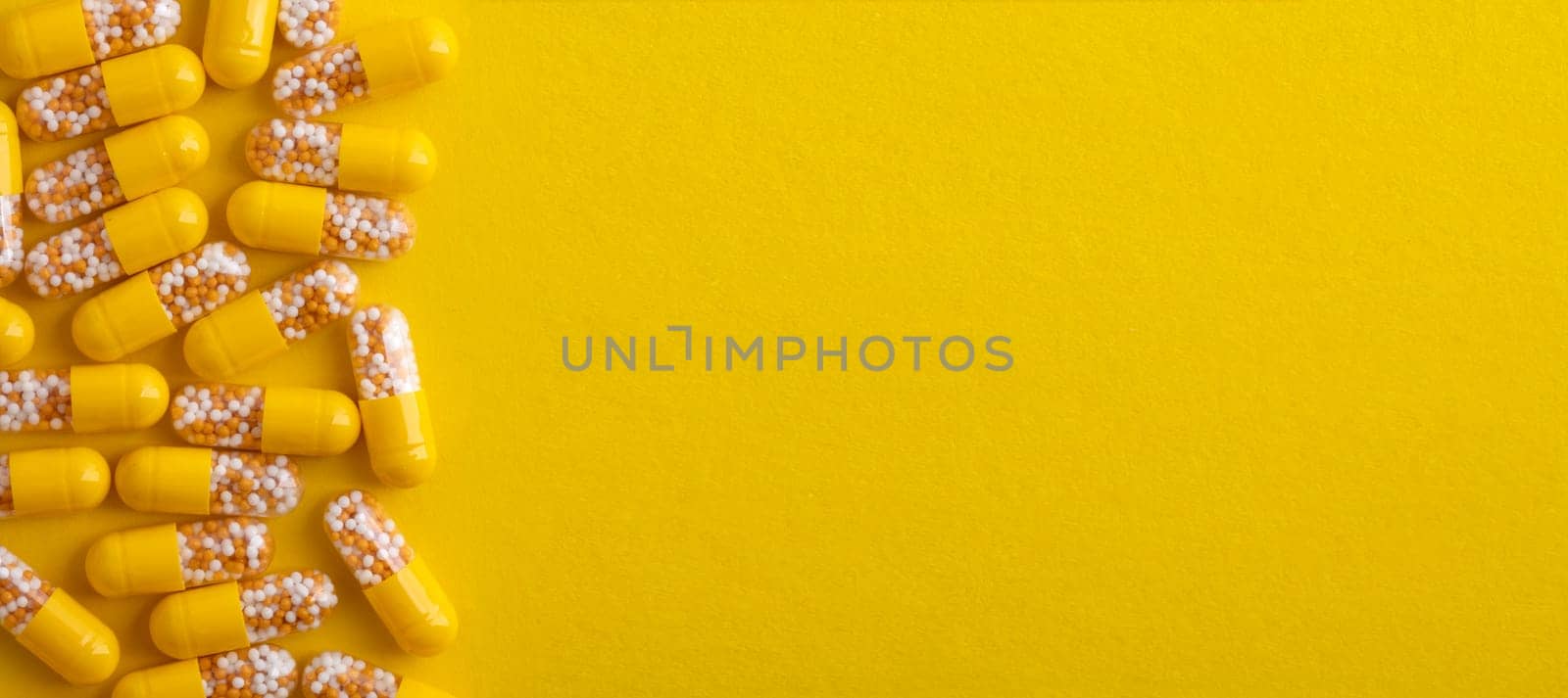 Top View from yellow pills over yellow background
