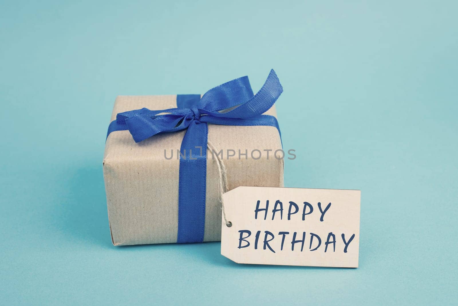 Gift box on a blue colored background, tag with fathers day