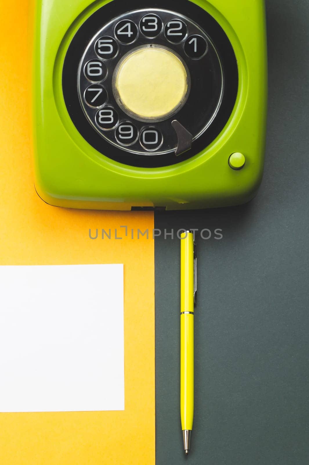 Classic phone. pen with a note. office background. vintage green telephone. old communication technology. copy space