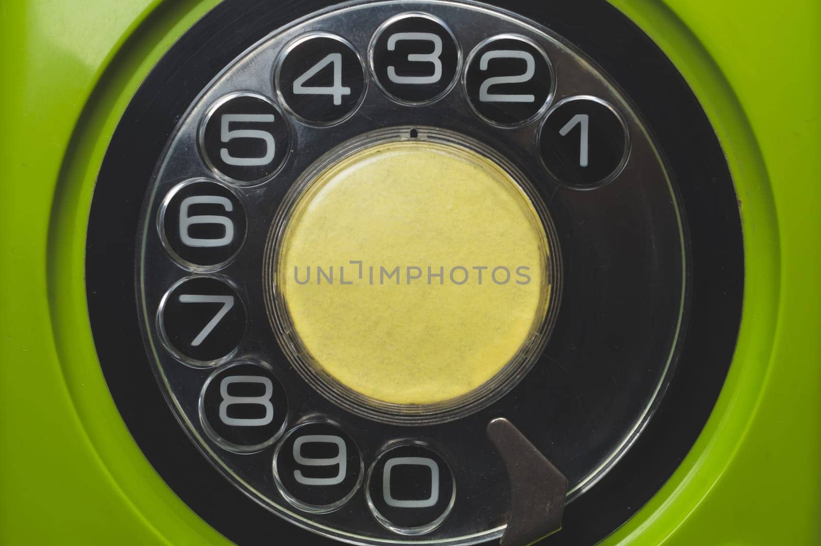 Vintage rotary phone close up. classic green telephone with round dial. old communication technology