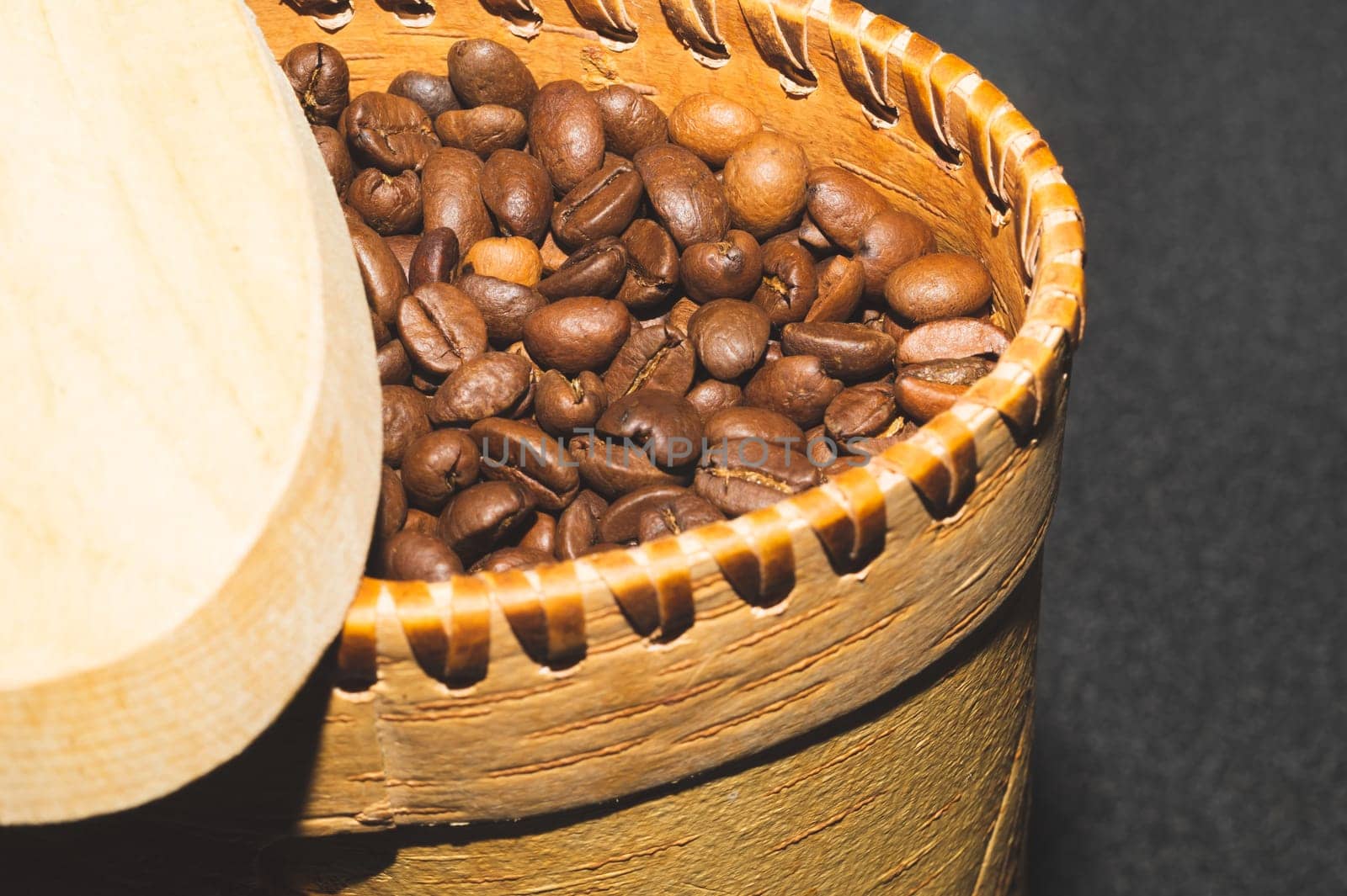 Coffee beans in a bark container. roasted coffee beans in a wooden jar