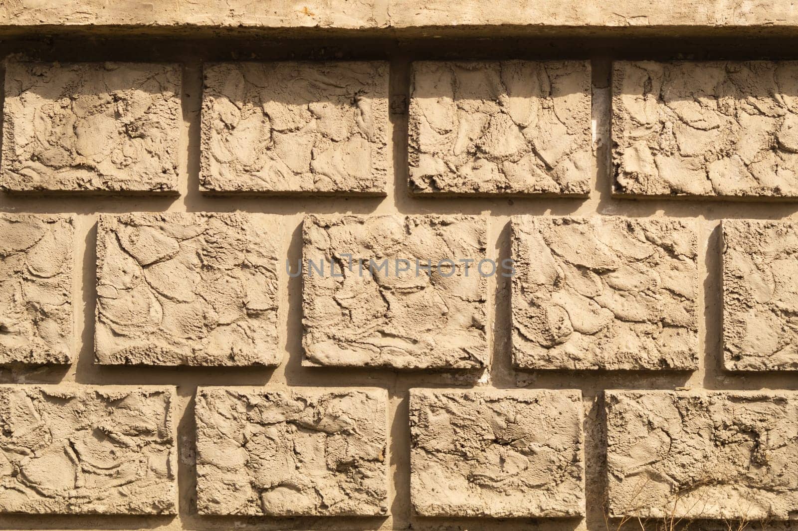 Old brick wall background. wall from squared bricks. cracked stone wall texture